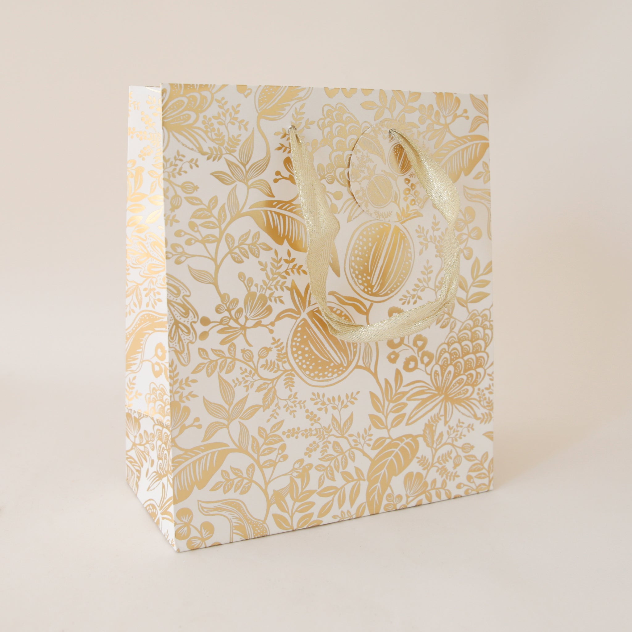 A 9.5&quot; x 8&quot; gold foiled gift bag with metallic cotton handles and a to and from tag.