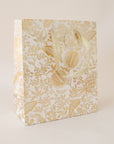 A 9.5" x 8" gold foiled gift bag with metallic cotton handles and a to and from tag.