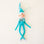 On a cream background is a teal elf ornament with bendy arms and legs and a teal loop for hanging.