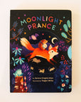 Hard cover children's book titles 'Moonlight Prance' in colorful capital lettering. Below is a woodland scene of various animals dancing around in the moonlight. Animals include a smiling fox, banjo playing hedgehog, mice and more. The background of the cover is solid black and accented with colorful star detailing. 