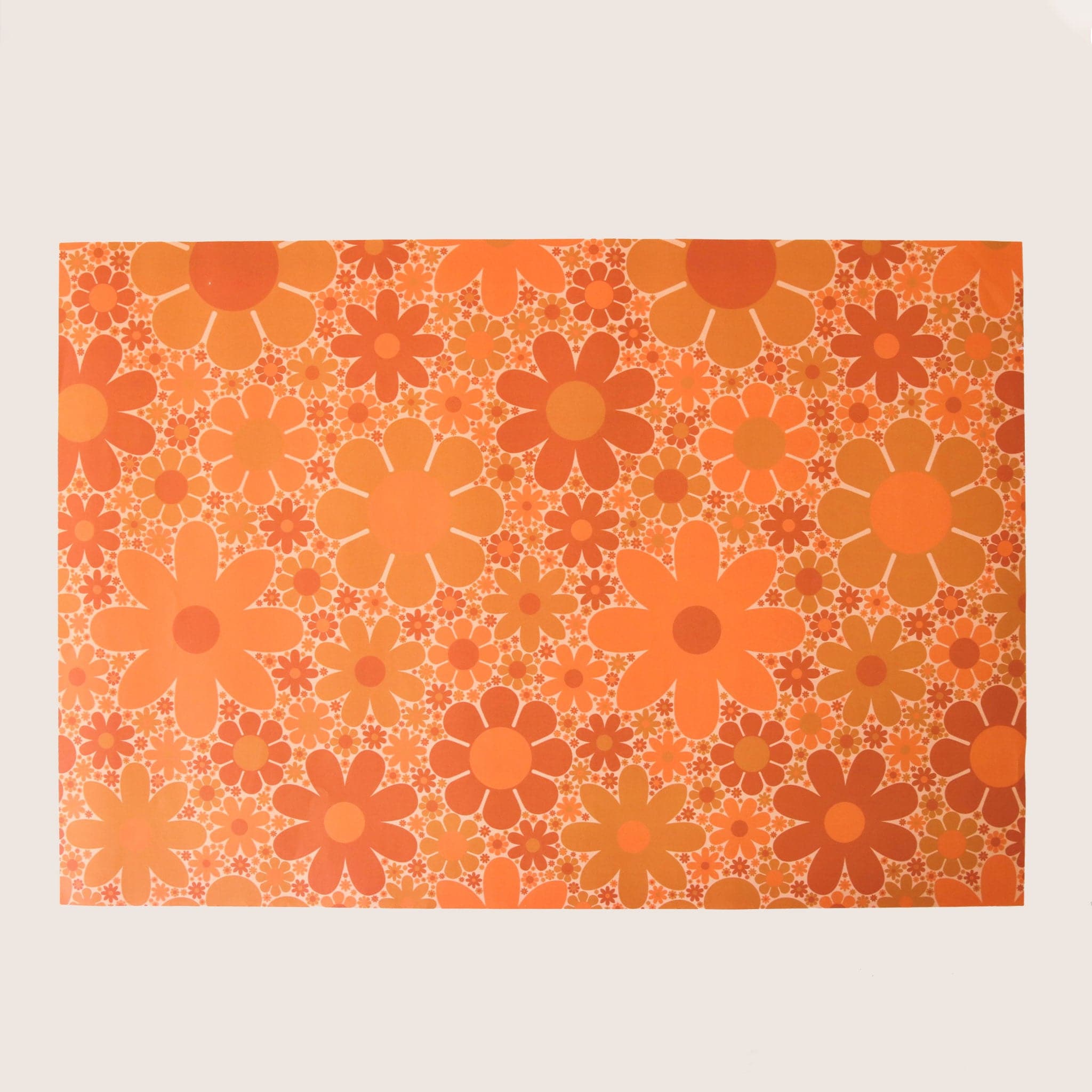 Wrapping paper with an orange daisy flower print. 