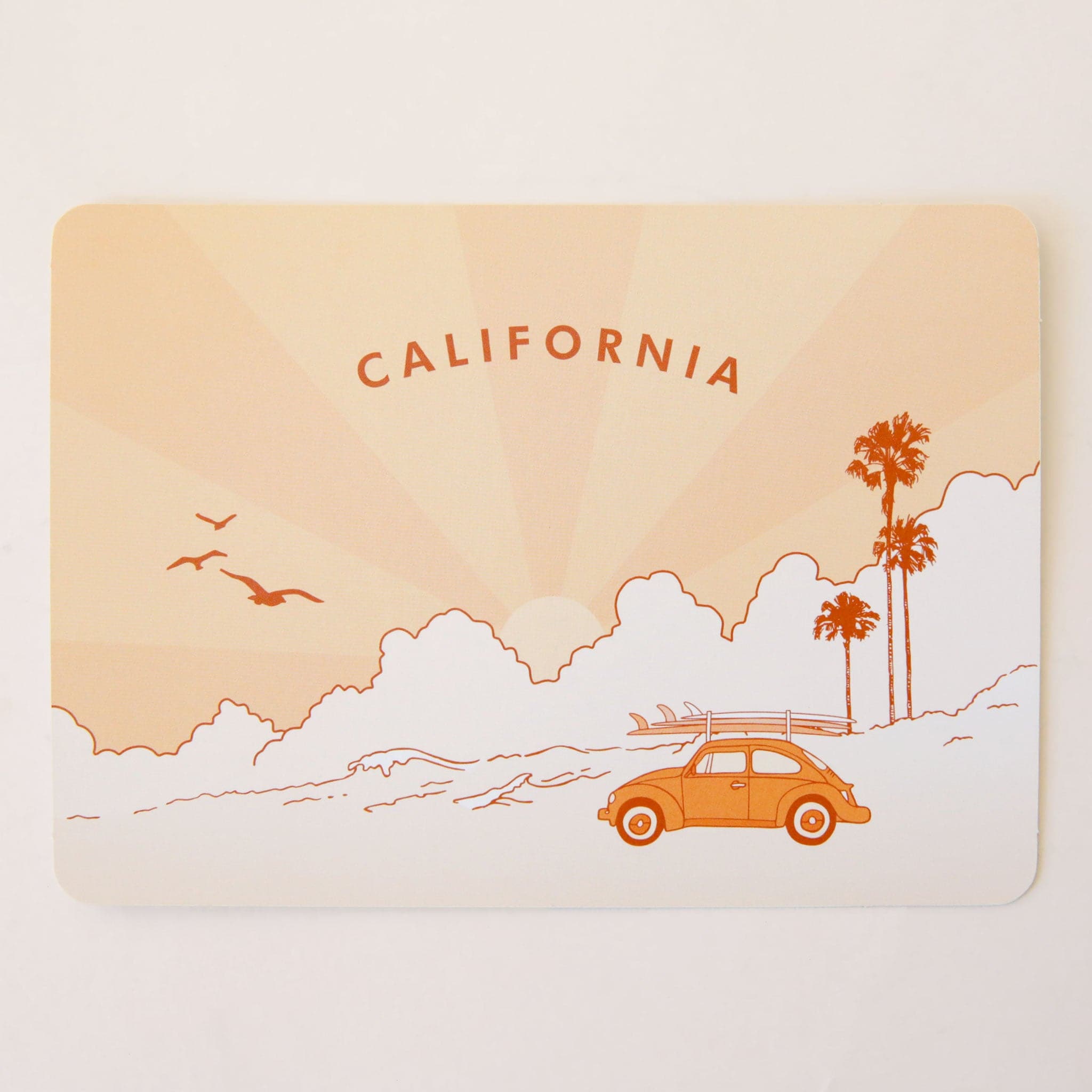 Peach postcard with a palm tree and a mustard VW bug with a surfboard. The text on the top says, "California".