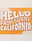 An orange postcard with 70's style text that reads, "Hello From Sunny California". 