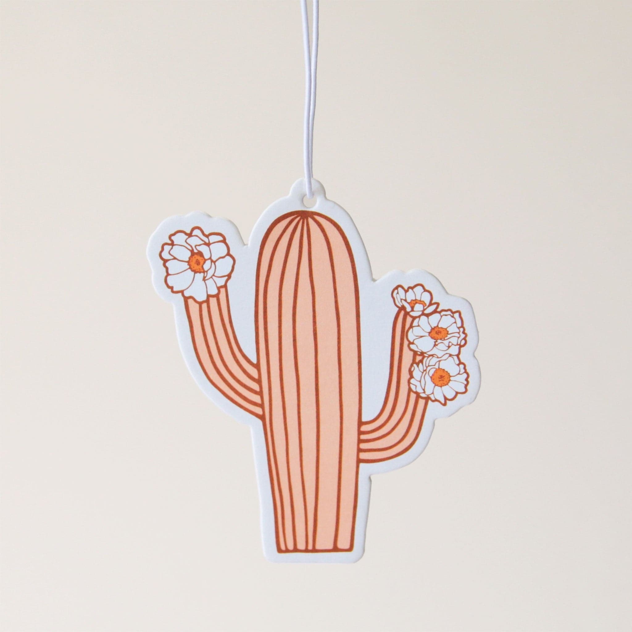 A burnt red and pink cactus air freshener with blooming cactus flowers.