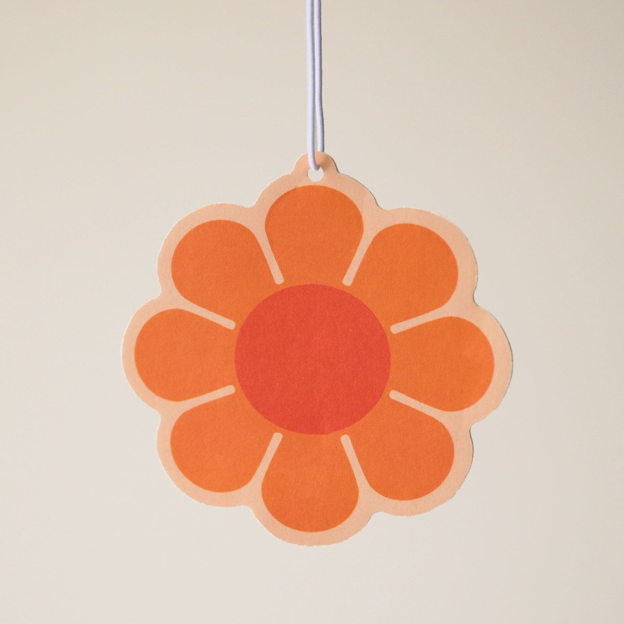 An orange 70's style daisy with a burnt red center.
