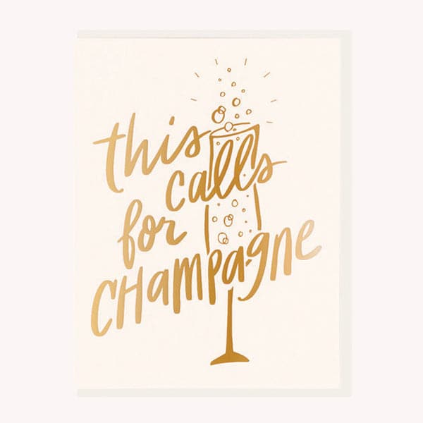This celebratory card reads &#39;this calls for champagne&#39; across a glass of bubbly in gold foil print. This card is a soft ivory and accompanied by a white envelope. 