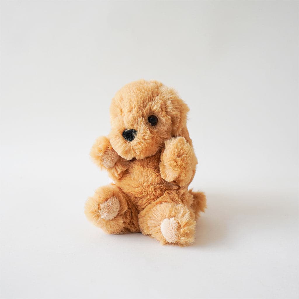 Playful stuffed golden retriever pup covered in enticingly soft golden fur. His puppy-dog face is complete with solid black gleamy eyes and nose.  