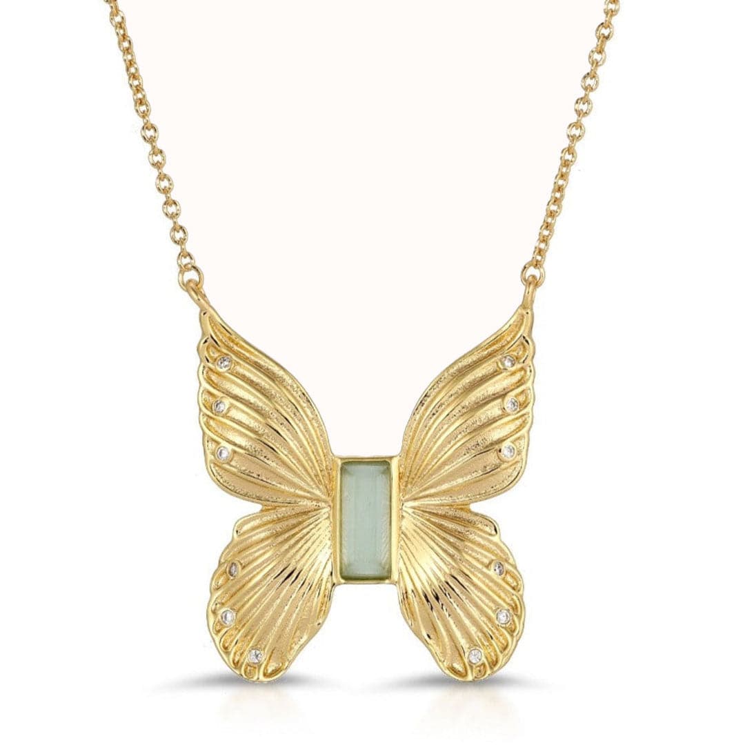 A gold butterfly necklace pendant, with a rectangle seafoam gem in the center along with three cz gems on each wing of the butterfly.