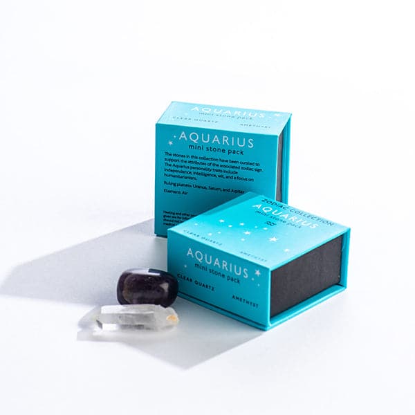 A bright blue magnetic box featuring the Aquarius&#39; mini stone pack. It includes a clear quartz crystal and an amethyst
