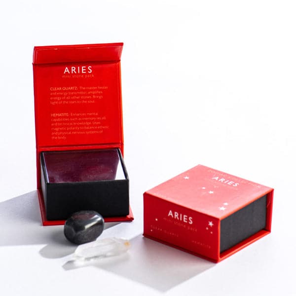 A red magnetic box featuring the Aries mini stone pack. It includes a clear quartz crystal and a tumbled hematite stone.