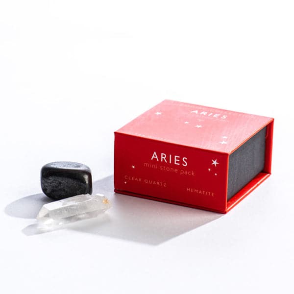 A red magnetic box featuring the Aries mini stone pack. It includes a clear quartz crystal and a tumbled hematite stone.