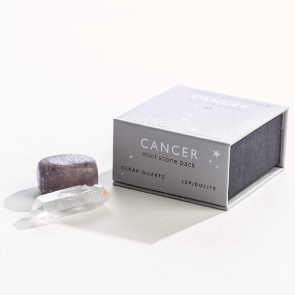 A grey magnetic box featuring the Cancer sign&#39;s mini stone pack. It includes a clear quartz crystal and a tumbled lepidolite stone.