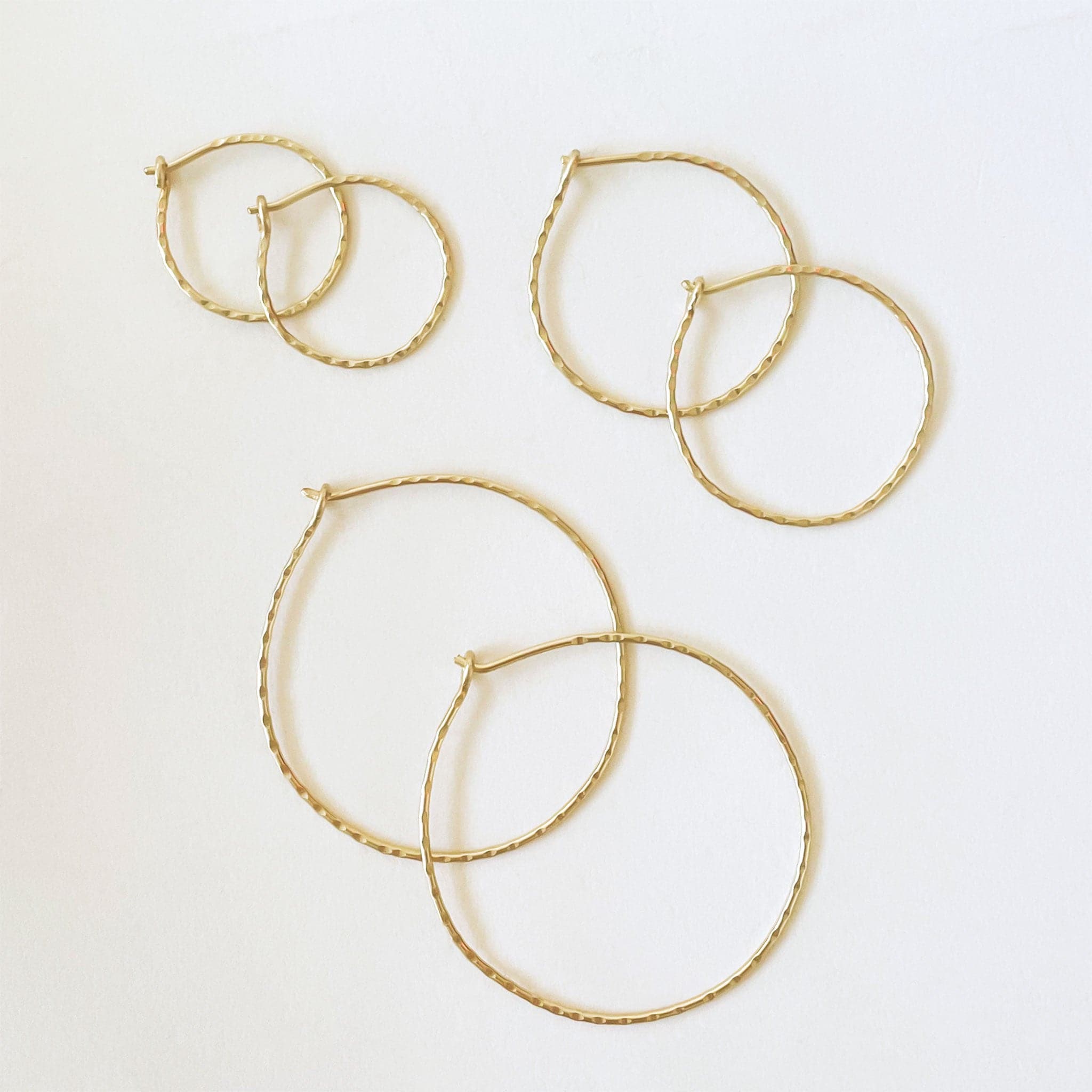 14k gold hammered hoops, shown here in the three sizes.