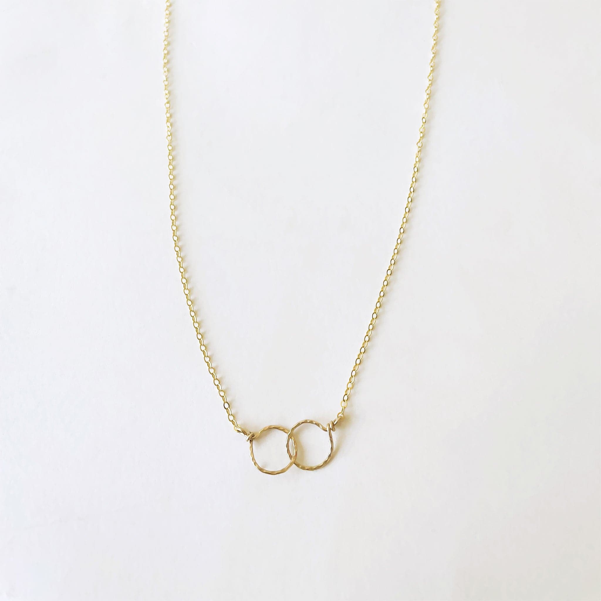 Two hammered 14k gold circles interlocked on a 16&quot; chain.