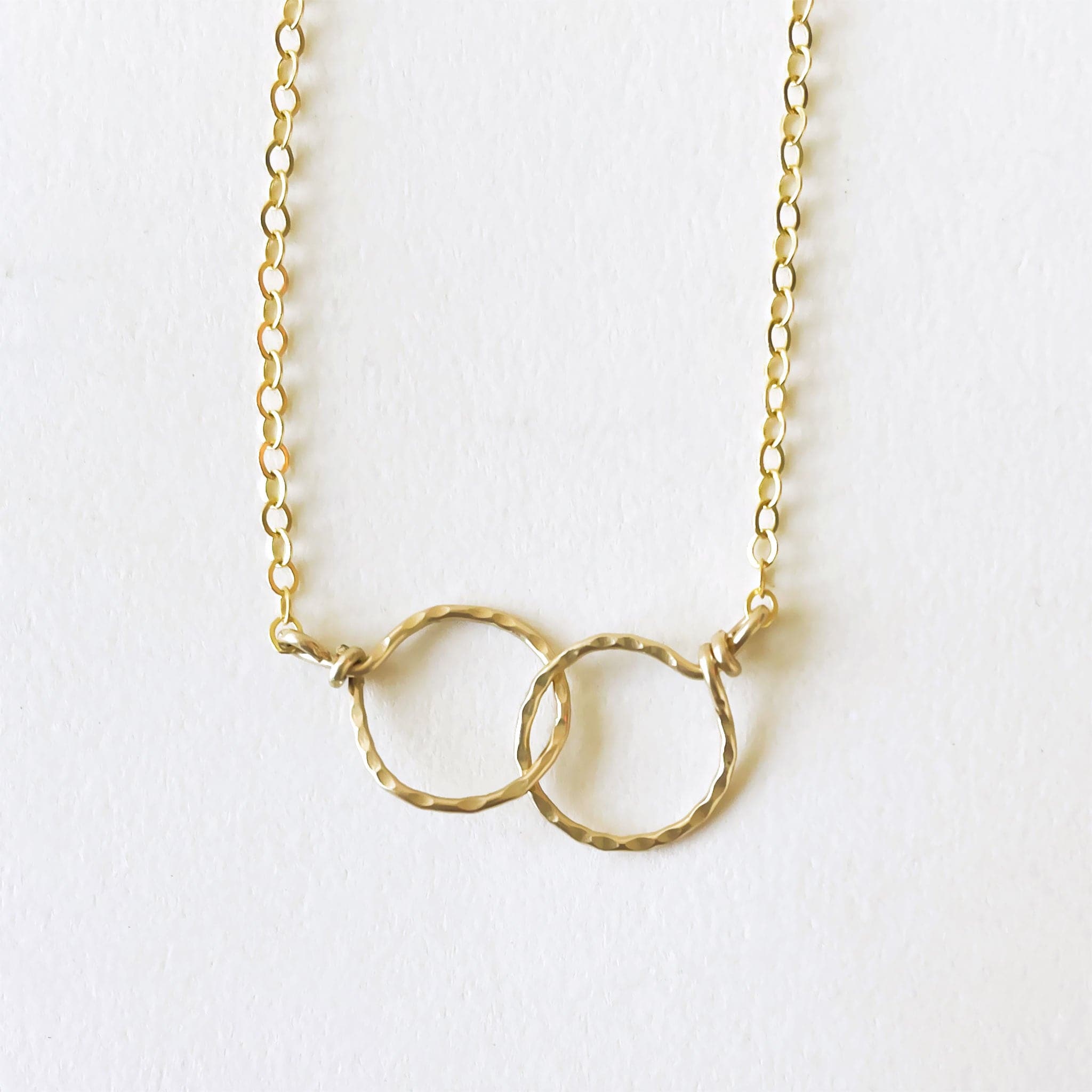 Two hammered 14k gold circles interlocked on a 16&quot; chain.