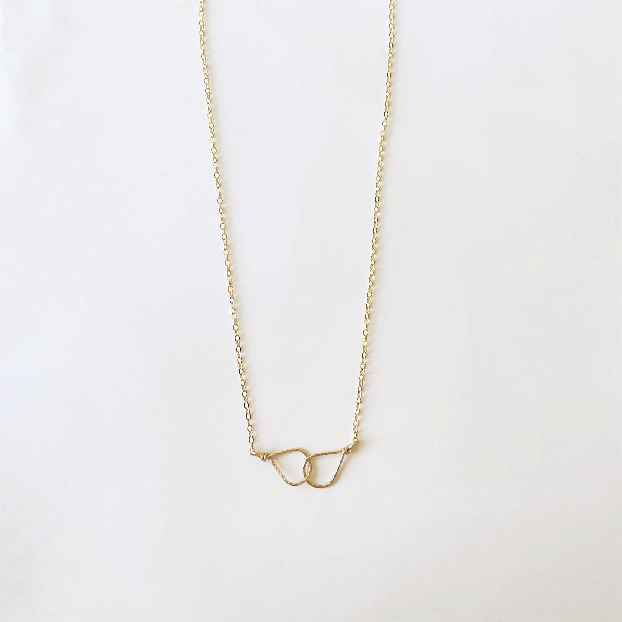 Two tear drop shapes interlocked on a 16&quot; gold chain.