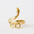 In front of a white background is a gold snake ring. The tail is at the bottom and the body and head curves around to the top of the ring. 