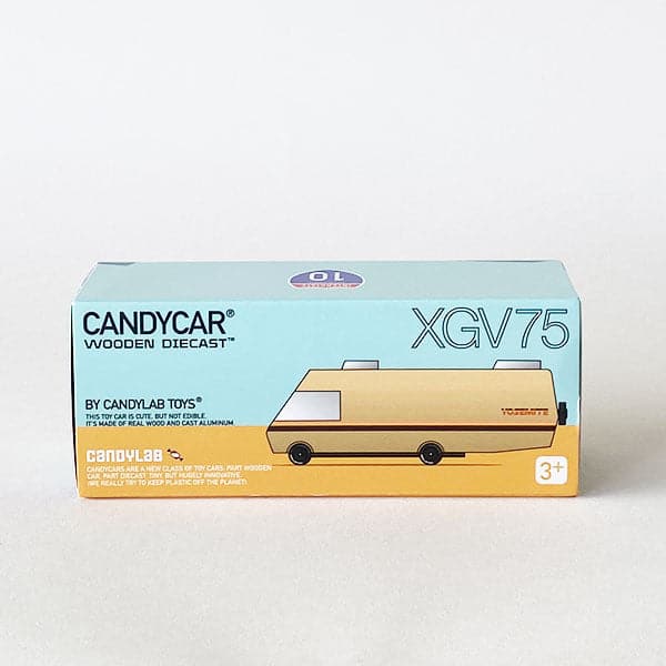 Pastel blue package of RV model reading &#39;CANDYCAR WOODEN DIECAST BY CANDYLAB TOYS XGV75&#39;. The box includes an image of the beige beech wood RV model with vintage striped detailing placed on light mustard flooring. 