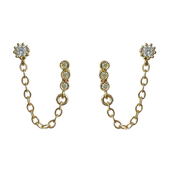 A pair of stud earrings with a chain connecting to another stud earring.