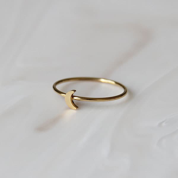Dainty thin gold band ring with a small moon in the center. Perfect for stacking along with your other favorite rings.