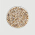 Birds eye view of a circular dish filled with earth toned pebbles. 