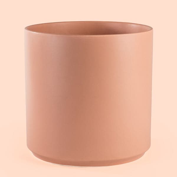 This cylinder ceramic pot is solid peach and is large enough to house a 7 gallon nursery pot.