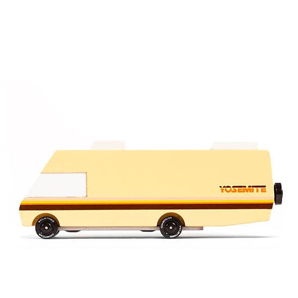Miniature 3.3 inch RV beige beech wood with white windows and dark brown wheel detailing. An orange and brown vintage stripe accent runs across its side for a classic feel. The RV model lays against a solid white background. 