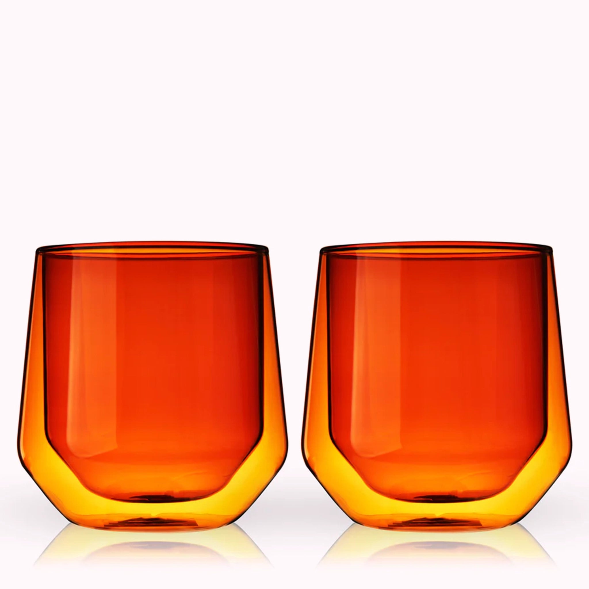 A set of glass double walled tumblers in an amber shade. 