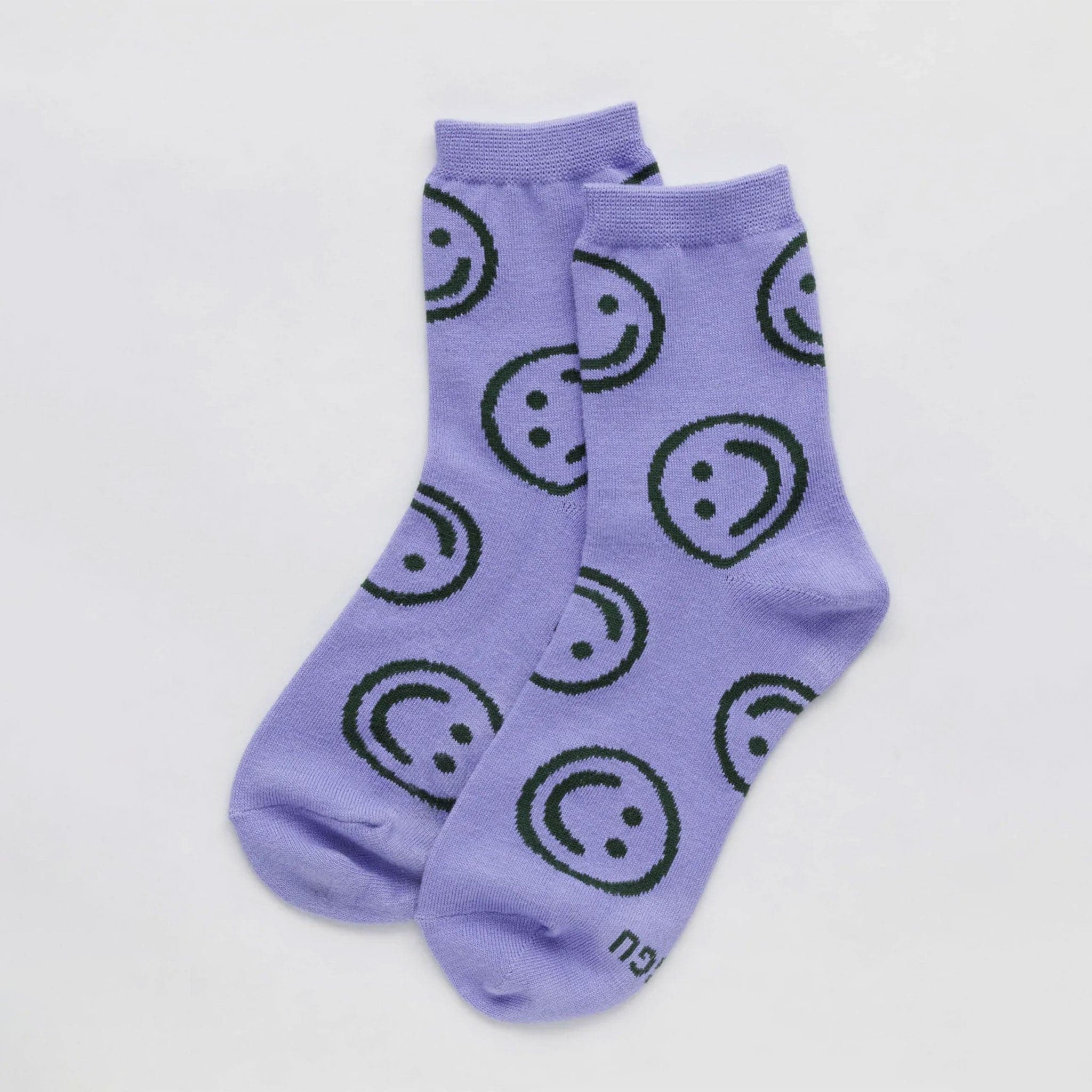 Purple mid calf socks with dark green smiley faces.
