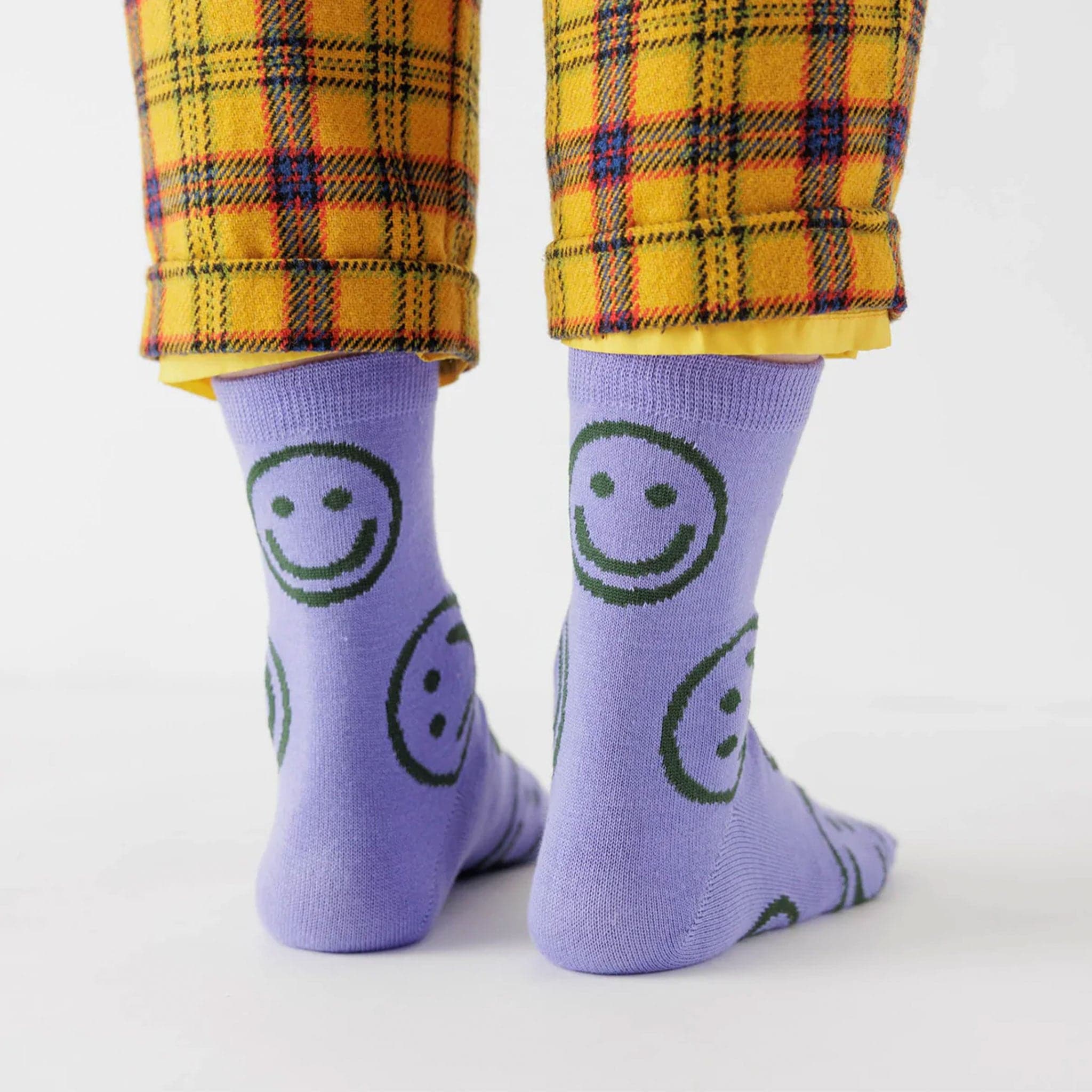 Purple mid calf socks with dark green smiley faces.