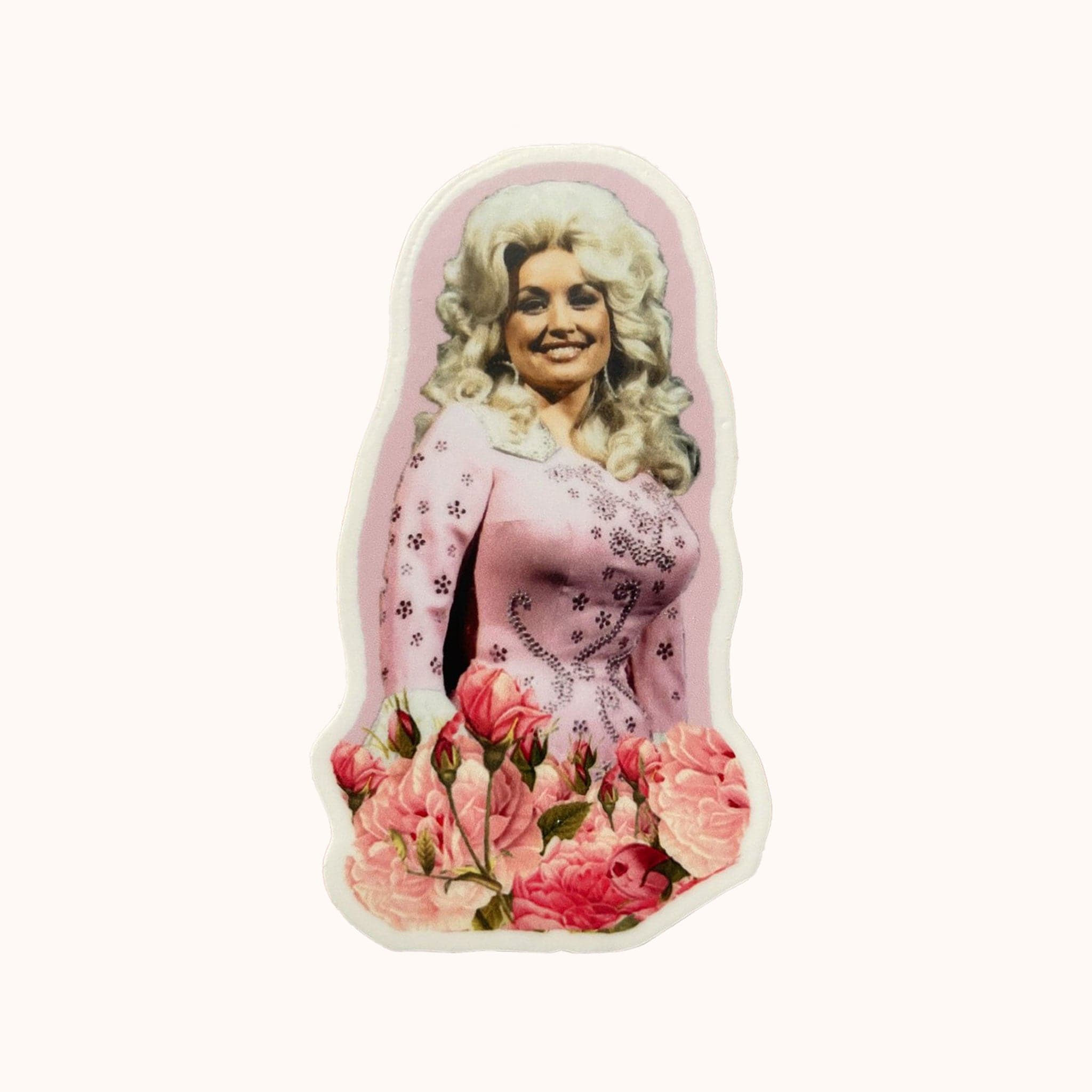 A pink cut out sticker of Dolly Parton in a pink outfit with her iconic voluminous hair and pink roses on the bottom.