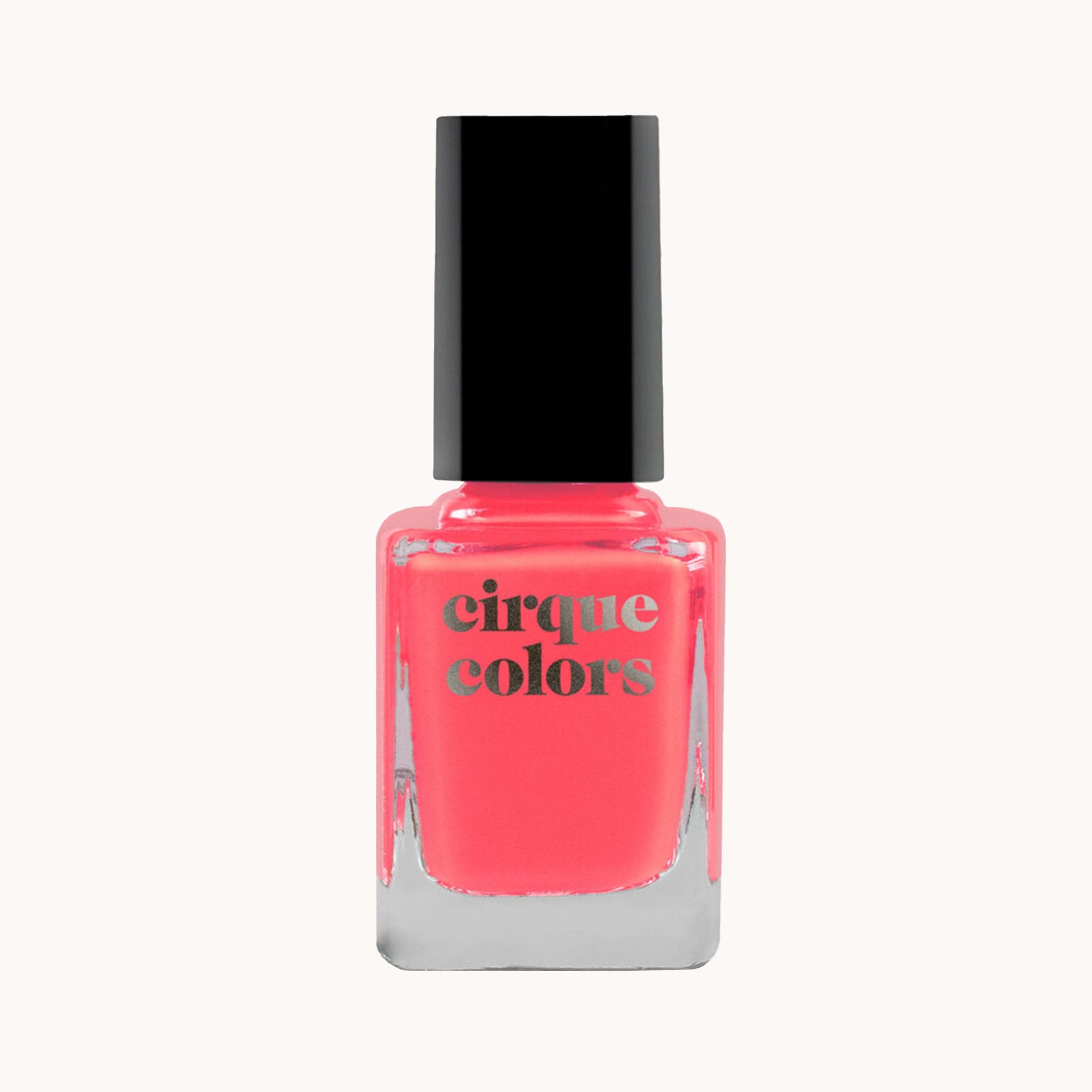 Nail polish with black lid with label, &quot;Cirque Colors.&quot; The polish color is a flamingo pink.