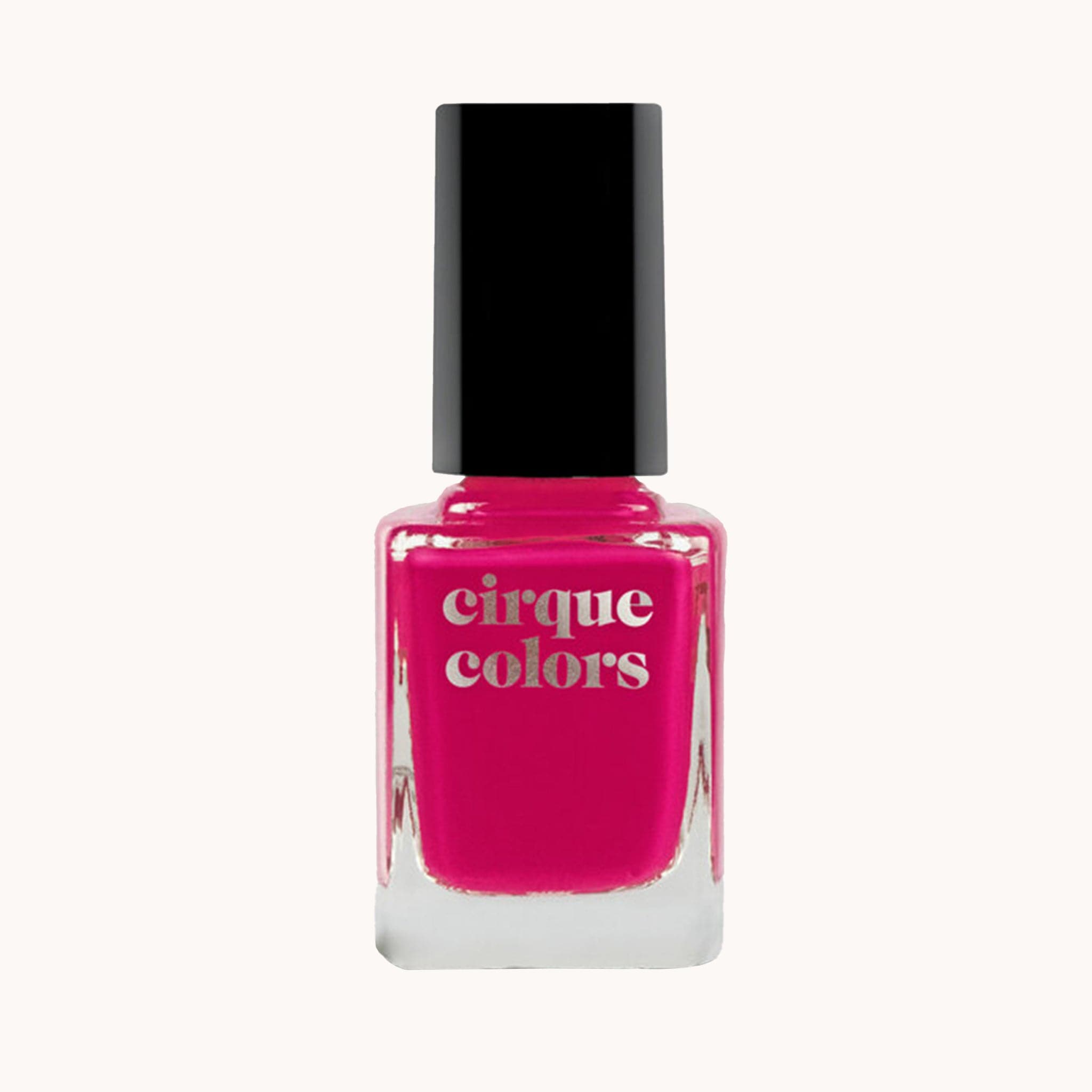On a white background is a hot pink nail polish bottle with a black lid and silver text on the front that reads, "Cirque Colors".