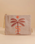 A greyish tan corduroy pouch with a single zipper going across the top and a palm tree, snake and sun graphic in the center.
