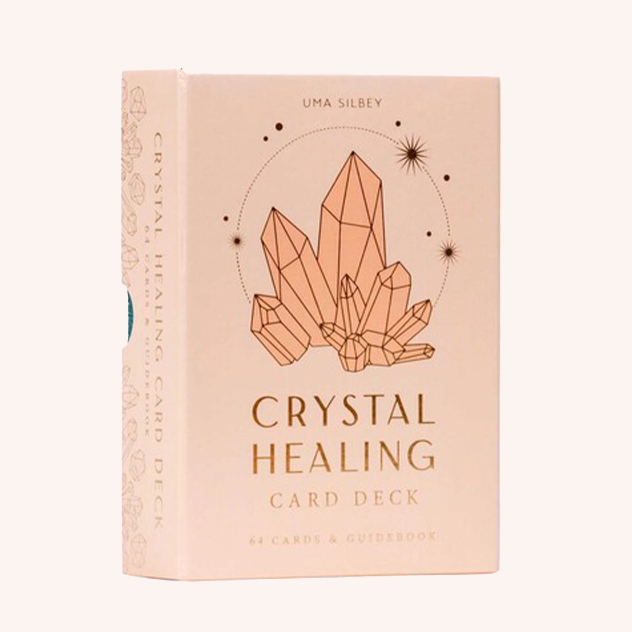 A salmon pink box of crystal cards with a graphic of crystals on the front and text that reads, "Crystal Healing Card Deck".