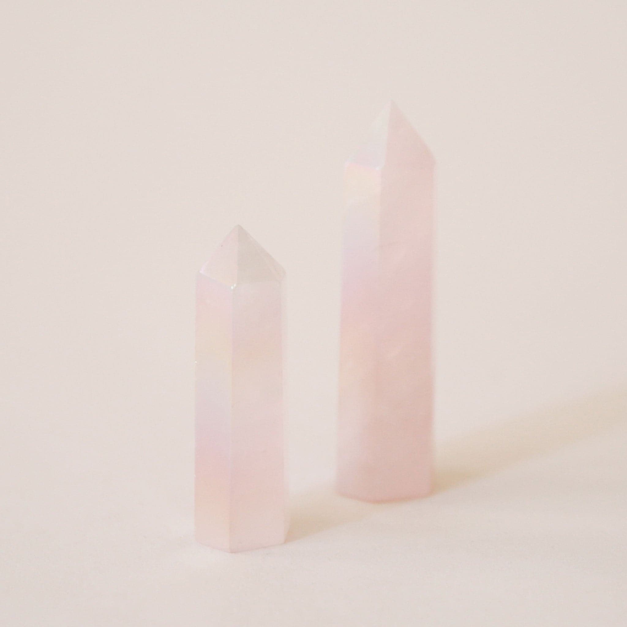 A rose quartz crystal with an iridescent quality to it.