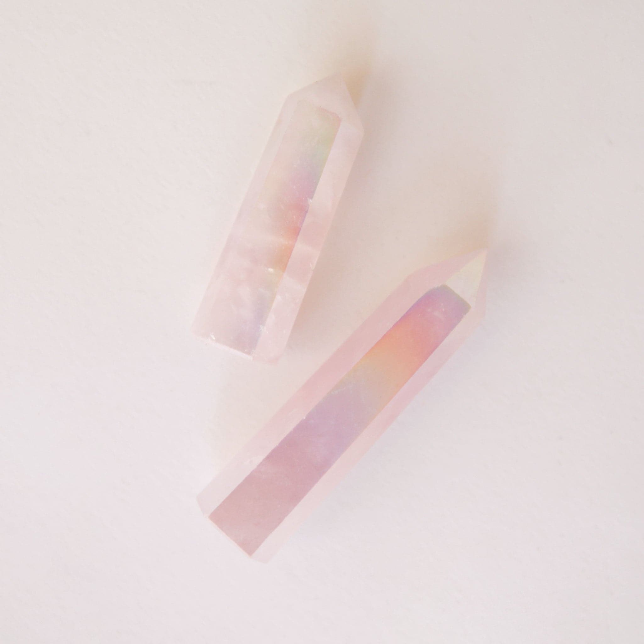 A rose quartz crystal with an iridescent quality to it. 