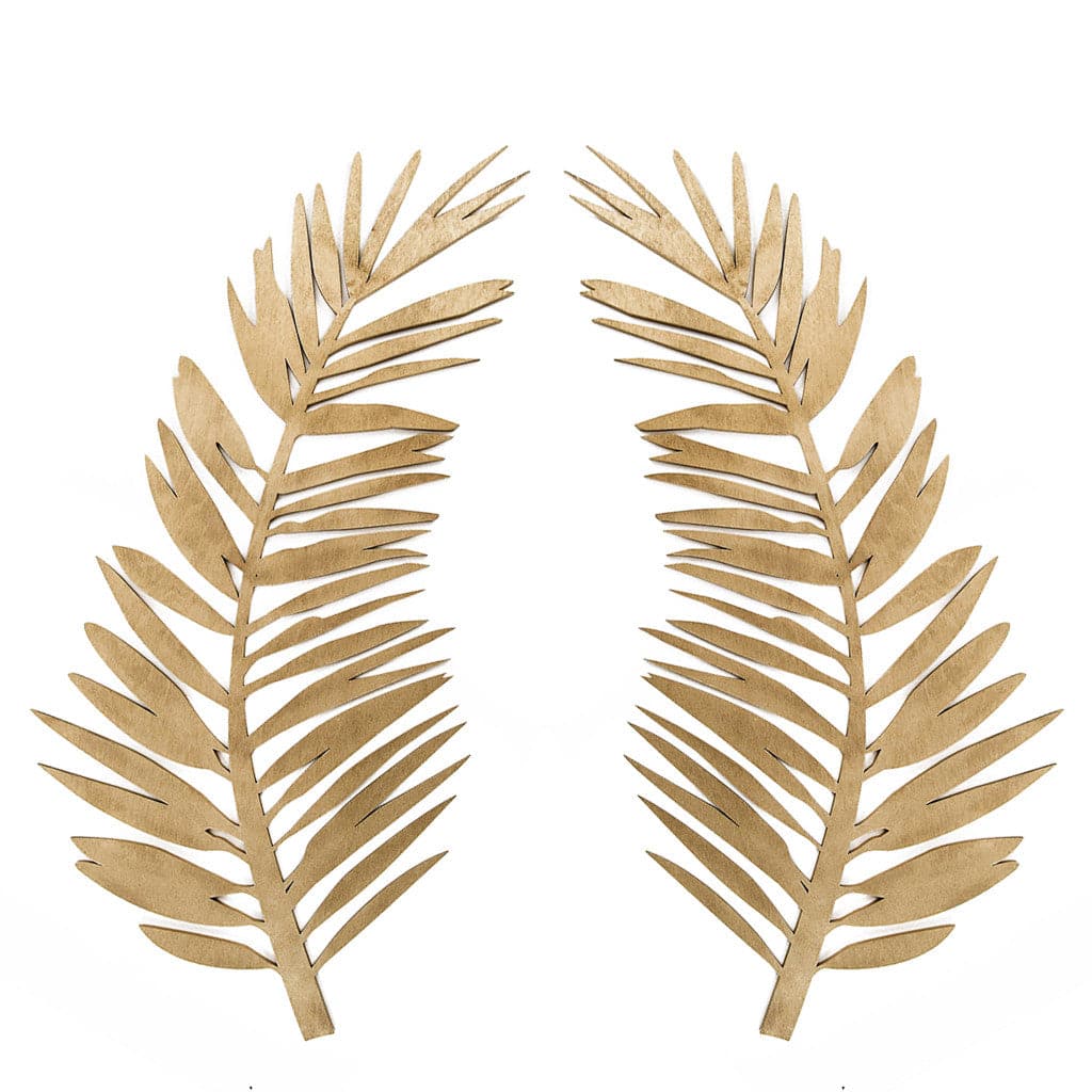 On a white background is a wooden cut out of a curved palm leaf.