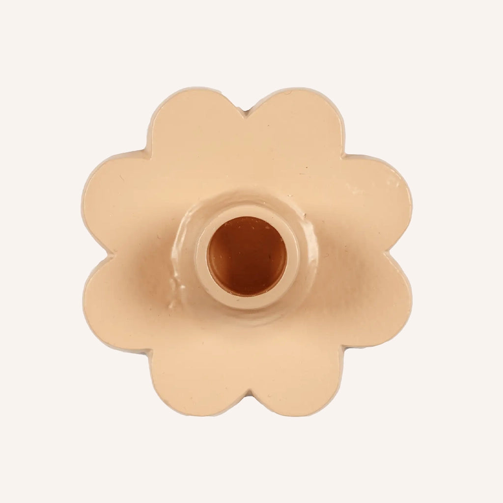 A short flower shaped taper candle holder in a blush pink shade.