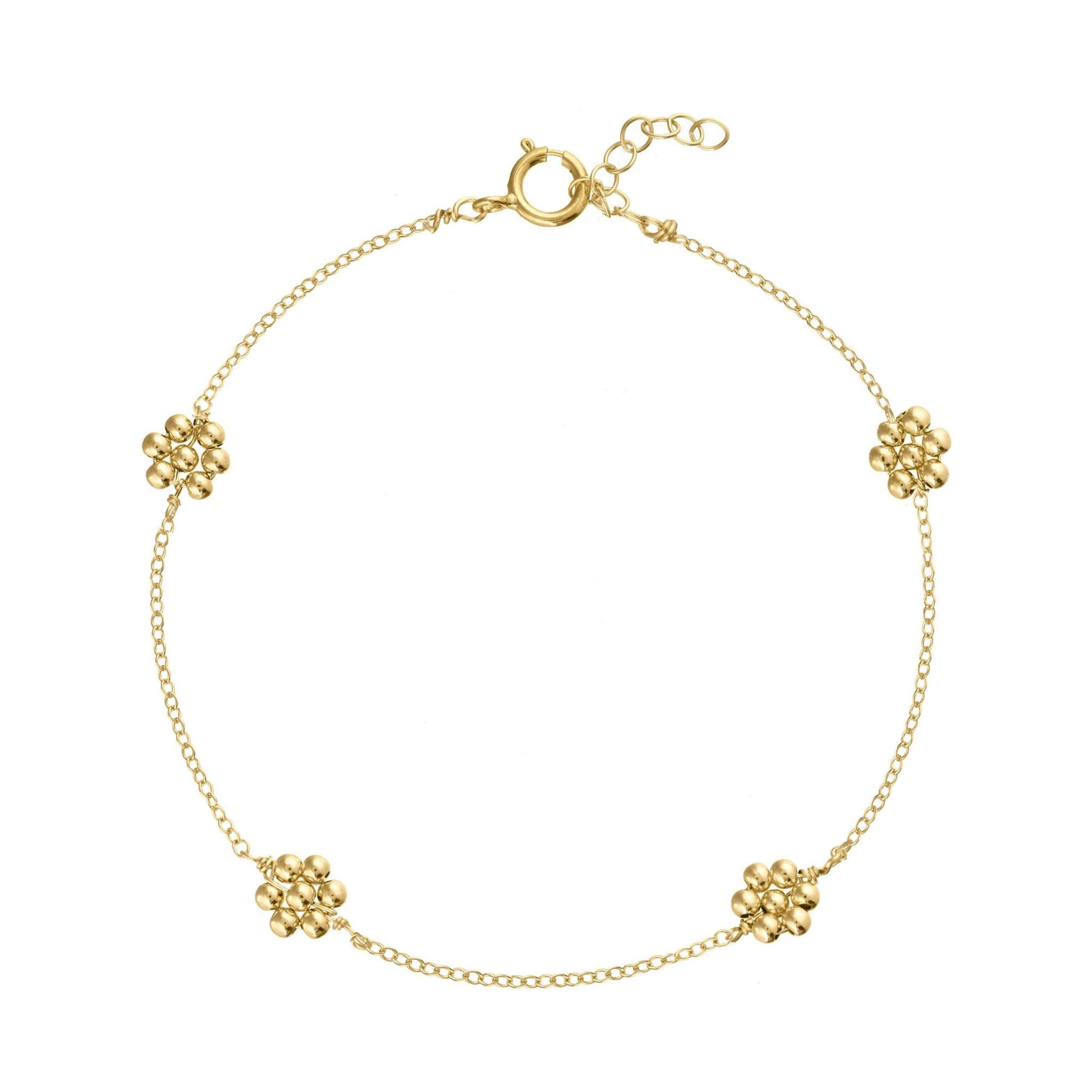 A dainty gold chain bracelet with four gold beaded daisies evenly placed on the chain.