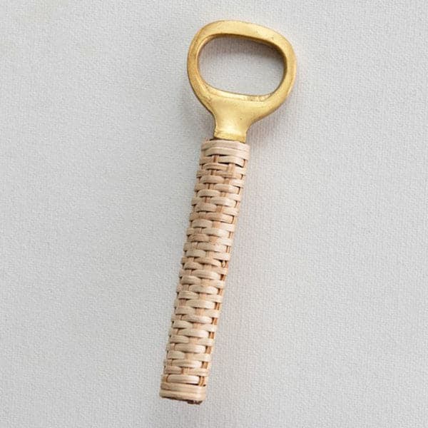 A brass bottle opener with a wrapped bamboo handle in a natural tan color.