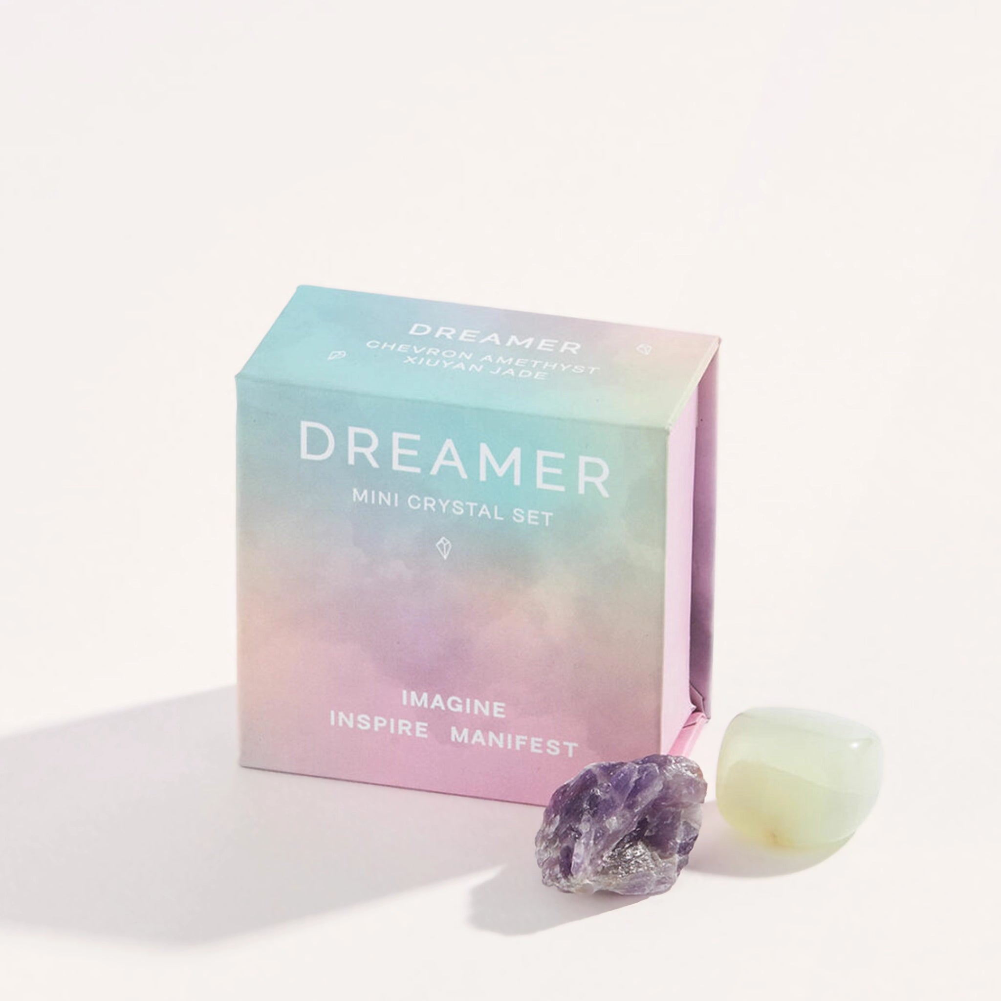 A light blue, and purple small box with a mini crystal set inside of it along with white text on the front that reads, &quot;Dreamer Mini Crystal Set. Imagine, Inspire, Manifest&quot;.