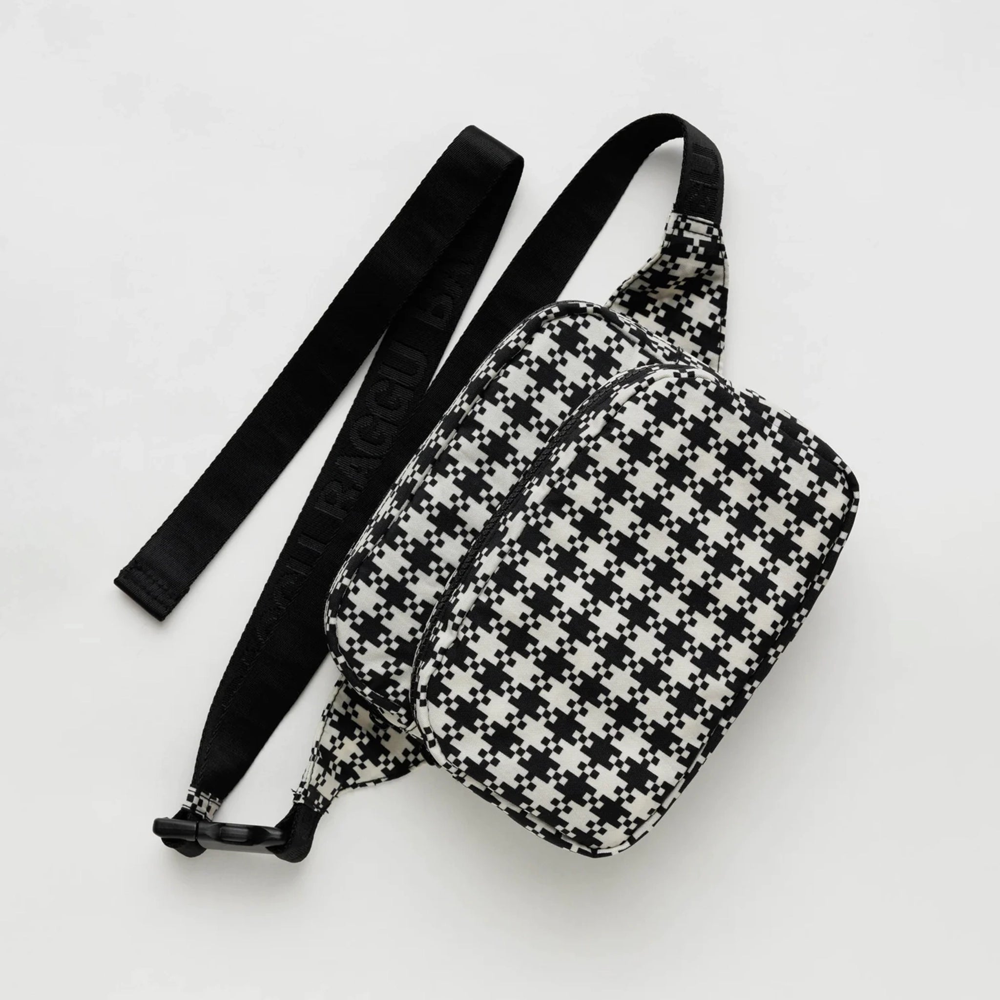 A black and white gingham nylon fanny pack with two zipper pockets and a black adjustable strap.