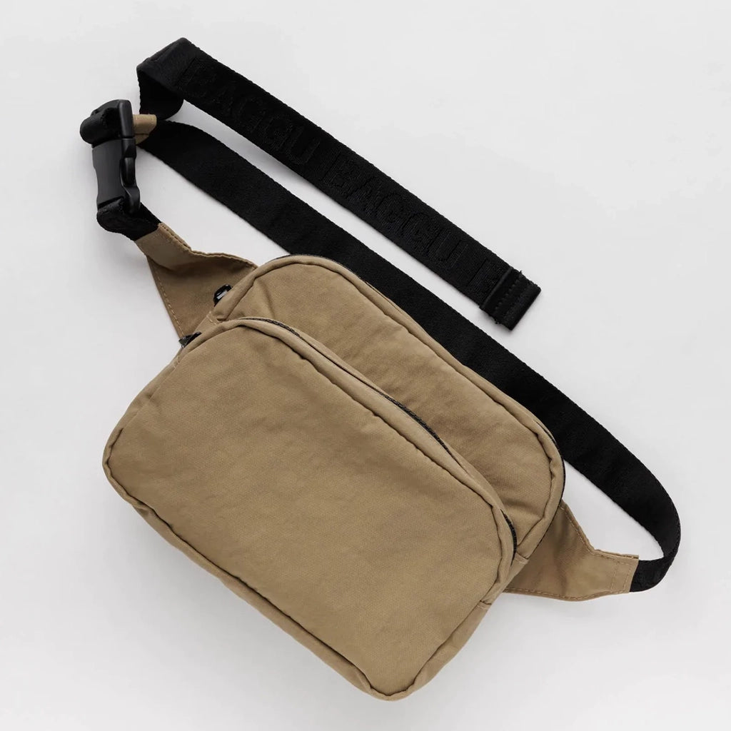 A dark khaki colored fanny pack with two zippers and a black adjustable strap.