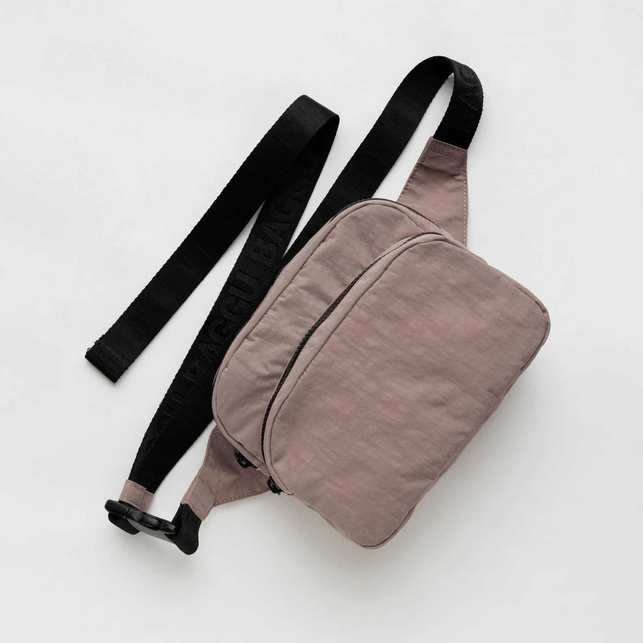 A taupe nylon fanny pack with two zipper pockets and a black adjustable strap.