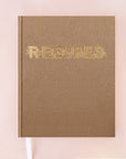 A latte brown recipe notebook that reads, "Recipes" in gold text with gold vine detailing around the letters.