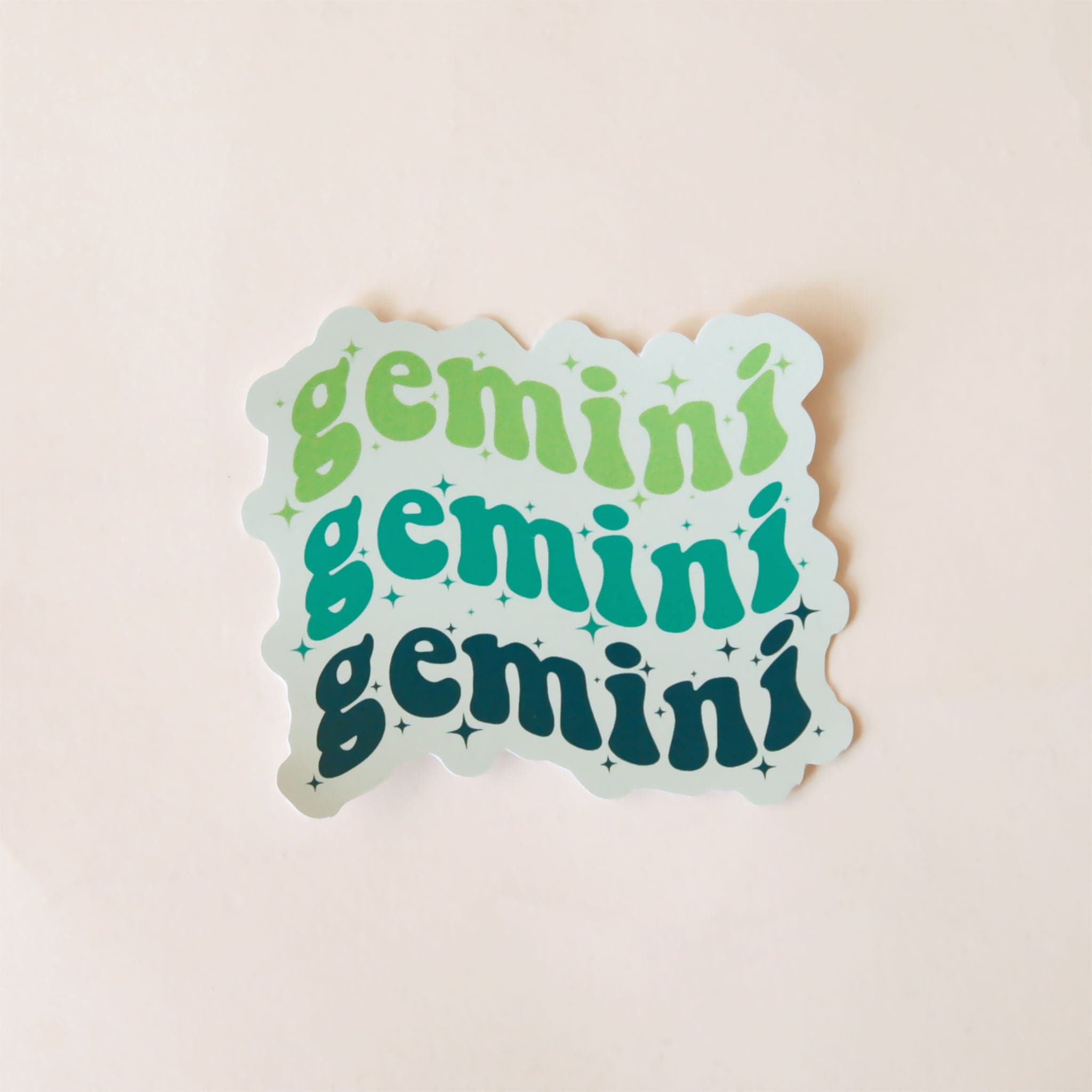 On a white background is a green sticker that has the word &quot;Gemini&quot; stacked on top of one another three times in a wavy design. 