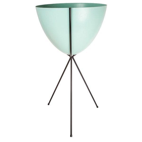 In front of a white background is a turquoise colored bullet planter. The planter has a wide top and narrows at the bottom. The planter is held up by a black metal stand. The stand has three black metal legs.