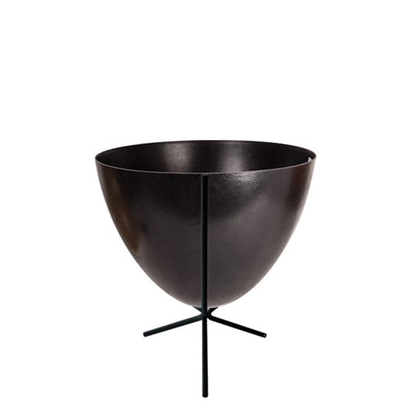 In front of white background is a black planter in a short black metal stand. The bullet planter is wide at the top and narrow at the bottom. The metal stand has three legs. 