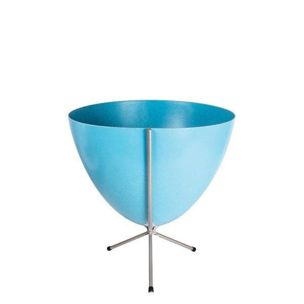In front of white background is a bright blue planter in a short silver metal stand. The bullet planter is wide at the top and narrow at the bottom. The metal stand has three legs. 